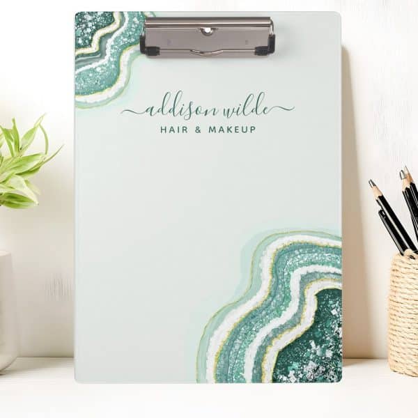 A Light Green Clipboard With An Agate Design And Addison Wilde Hair &Amp; Makeup Printed On It.