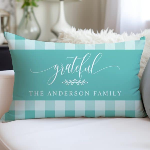 Teal Rectangular Pillow With A White Gingham Border And The Word Grateful In A Script Font, Along With The Text The Anderson Family.