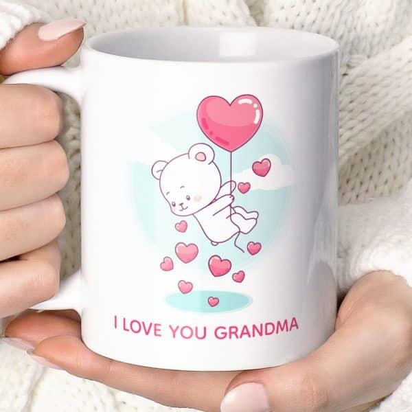 White Coffee Mug Featuring A Cartoon White Bear Holding A Heart-Shaped Balloon, Surrounded By Smaller Hearts. Text At The Bottom Reads I Love You Grandma.