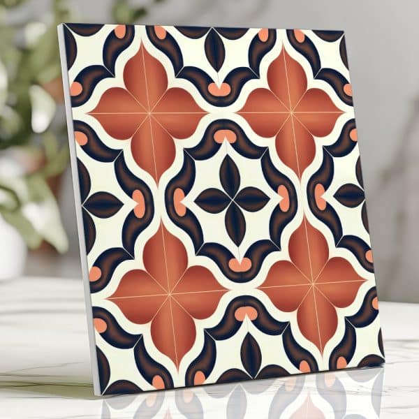 Square Tile With A Repeating Pattern Of Orange And Dark Blue Floral Shapes On A Cream Background.