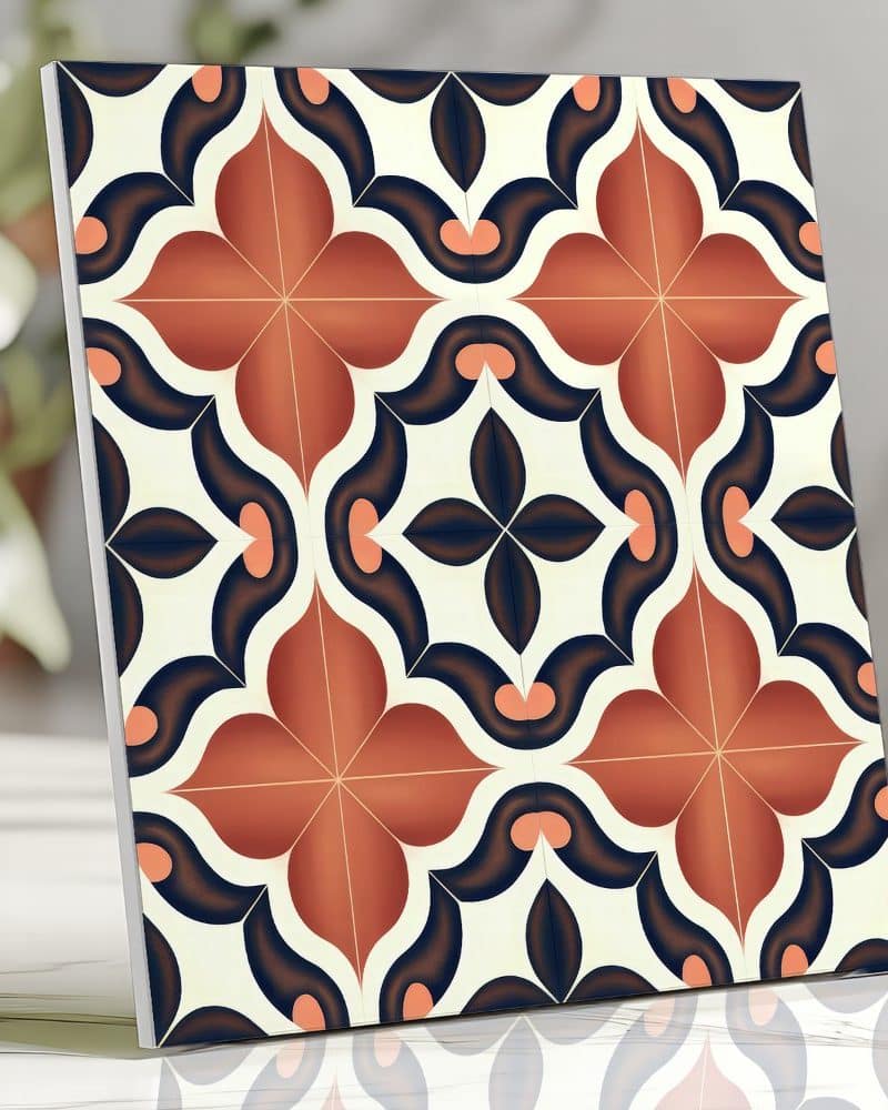 Square tile with a repeating pattern of orange and dark blue floral shapes on a cream background.