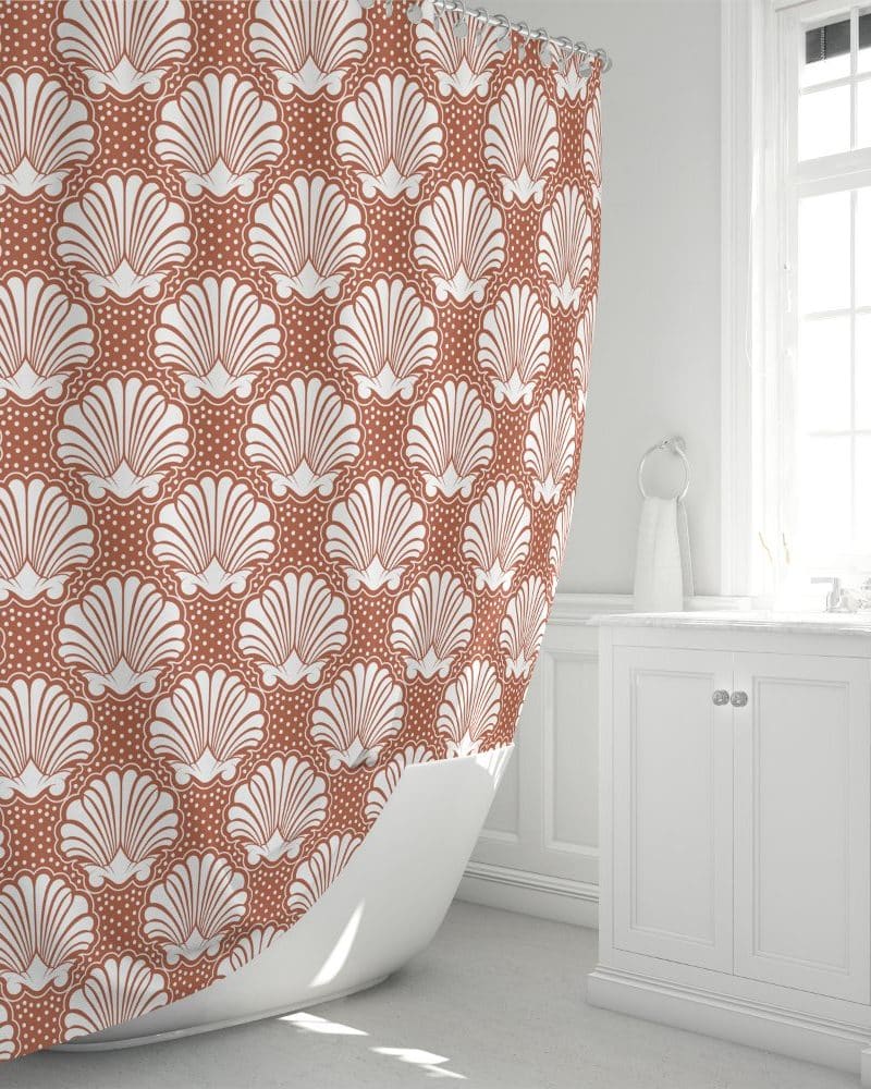 Rust-colored shower curtain with a repeating pattern of white stylized seashells.