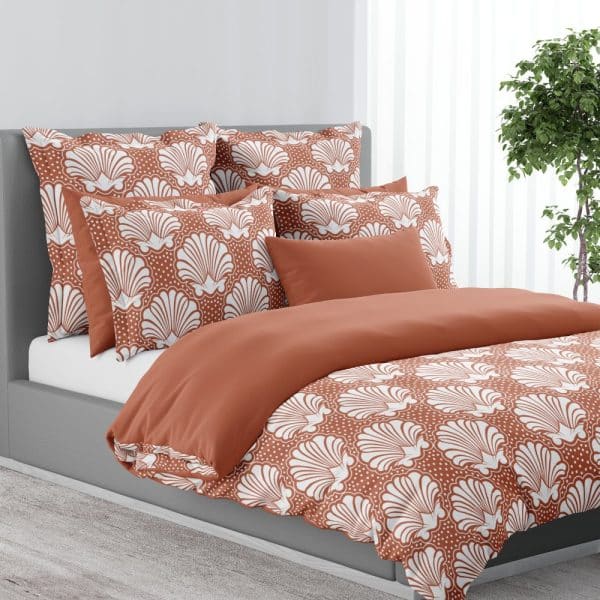 Rust-Colored Duvet Cover And Pillow Shams With A White Seashell Pattern.