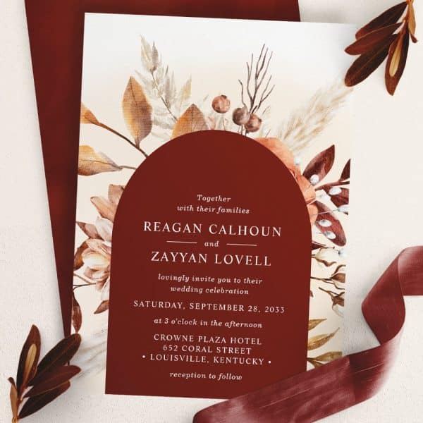 Wedding Invitation With Autumnal Floral Design; Names Reagan Calhoun And Zayyan Lovell.