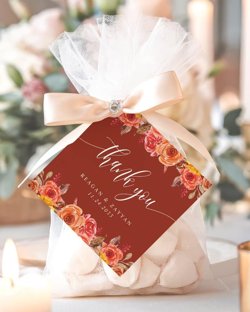 Wedding favor bag with a thank you tag featuring orange and red floral design.