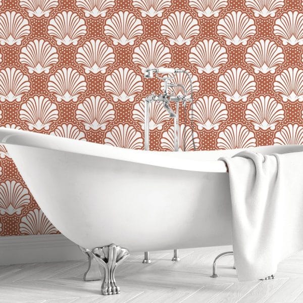 White Clawfoot Bathtub In Front Of A Rust-Colored Wall With A White Seashell Pattern.