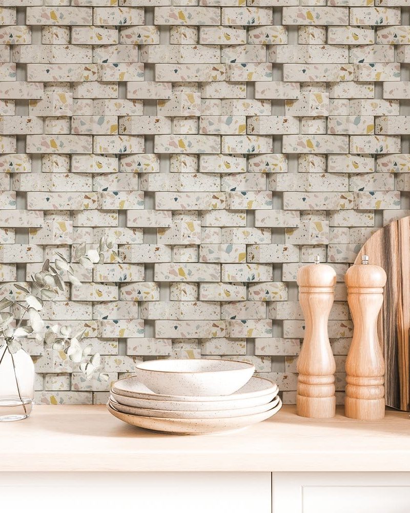 Terrazzo brick pattern wallpaper with stacked dishes, salt and pepper shakers, and a cutting board on a kitchen counter.