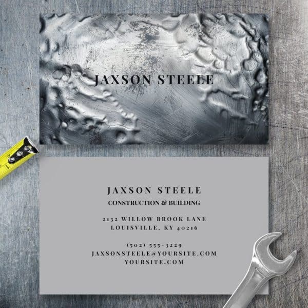 Business Card For Jaxson Steele Construction &Amp; Building. The Card Features A Metallic Textured Background.