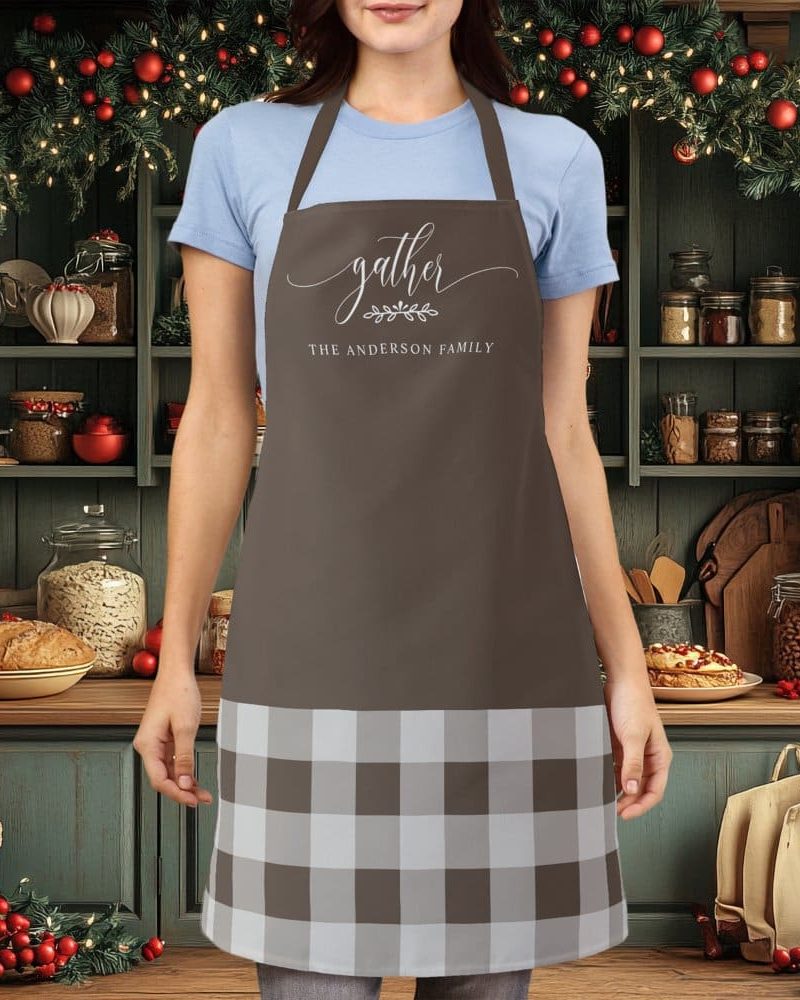 Brown apron with a white and brown buffalo plaid bottom and the words Gather The Anderson Family in a script font.