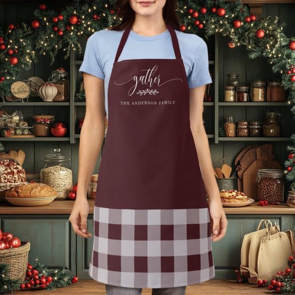 Burgundy Apron With A Gray And Burgundy Gingham Bottom And The Words Gather, The Anderson Family.