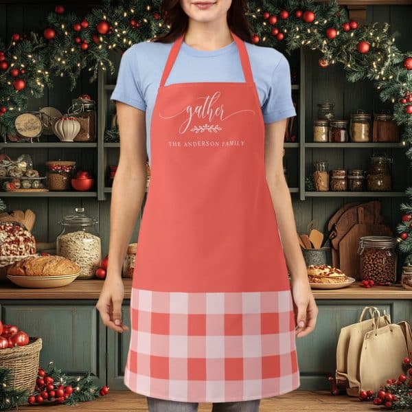Coral Apron With A Gingham Bottom And The Words Gather The Anderson Family.