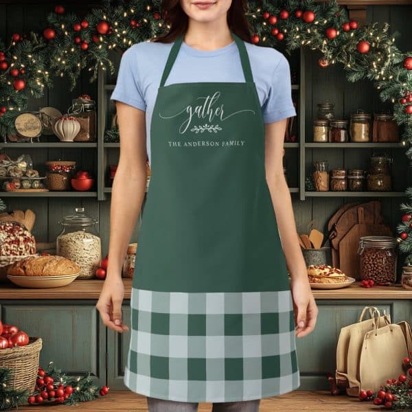 Green Apron With A Buffalo Plaid Bottom And The Words Gather, The Anderson Family On The Top.