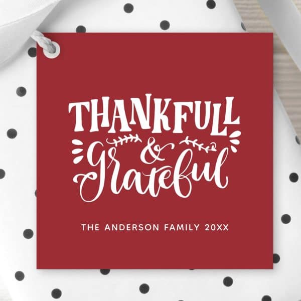 Red Gift Tag With White Lettering That Says Thankful &Amp; Grateful, With The Anderson Family Name And Year Below.