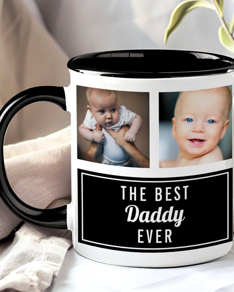 Coffee mug with black handle and interior, featuring two photos of a baby and text that says, The Best Daddy Ever.