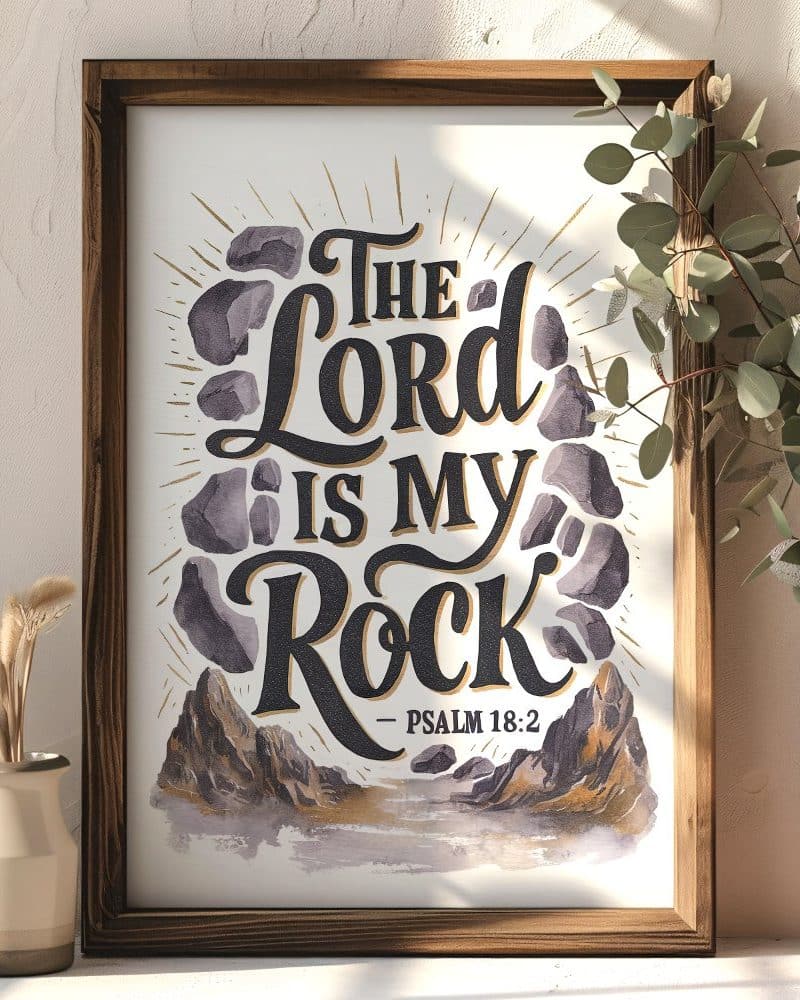 Framed print with the text The Lord is my Rock Psalm 18:2. The text is stylized with stones and a mountain landscape.