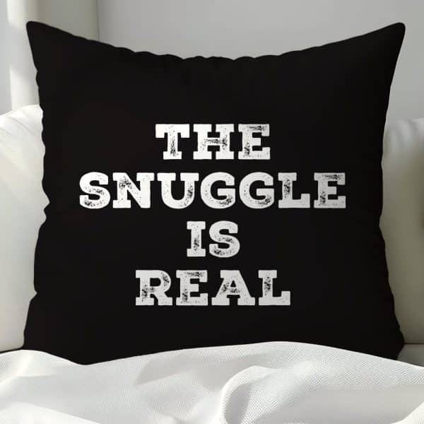 Black Pillow With White Text Reading The Snuggle Is Real.