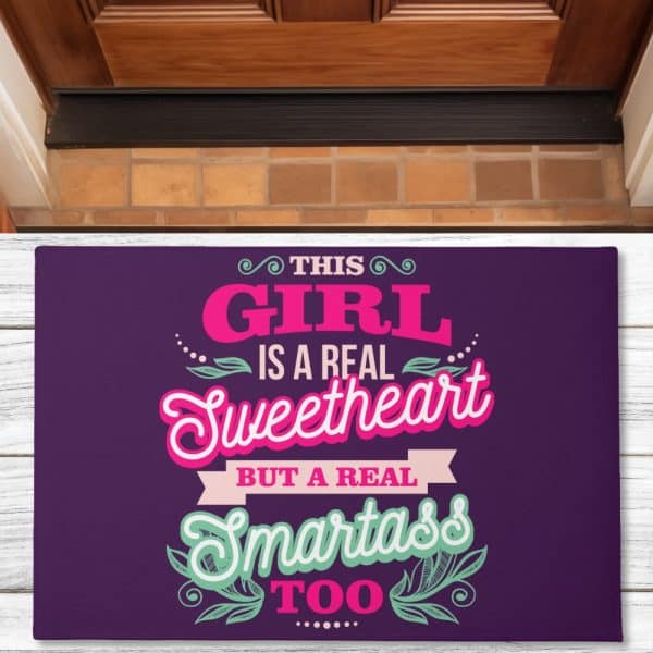Purple Doormat With A Saying: This Girl Is A Real Sweetheart But A Real Smartass Too.
