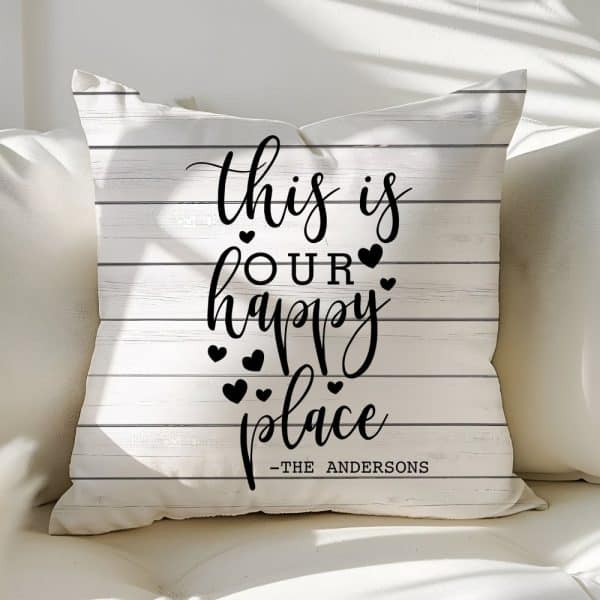 White Pillow With Black Text Reading This Is Our Happy Place, And The Andersons.