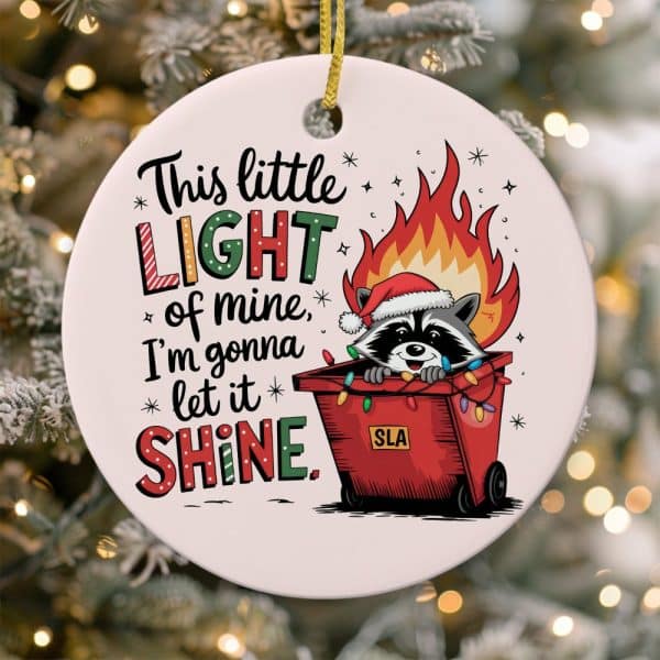 Christmas Ornament Featuring A Raccoon Wearing A Santa Hat Inside A Dumpster Decorated With Christmas Lights And Flames, With Text Reading This Little Light Of Mine, I'M Gonna Let It Shine.