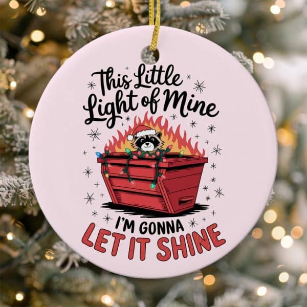 Round Christmas Ornament Featuring A Raccoon Wearing A Santa Hat Inside A Dumpster Decorated With Christmas Lights And Flames. Text Reads, This Little Light Of Mine, I'M Gonna Let It Shine.