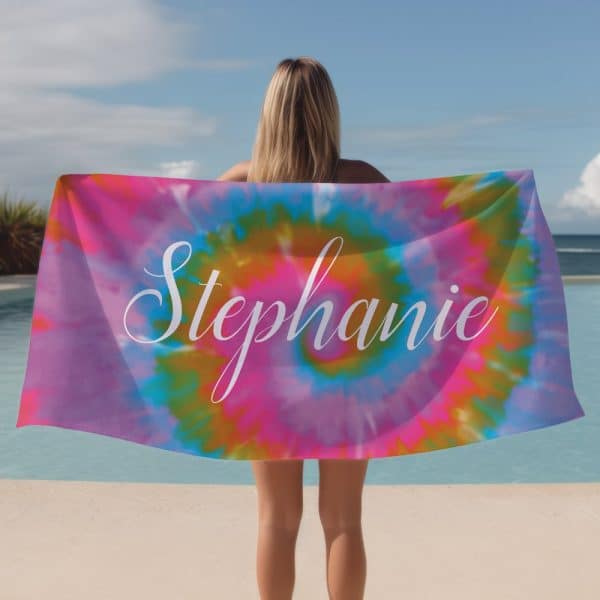 Woman Holding A Tie-Dye Beach Towel With The Name Stephanie On It.