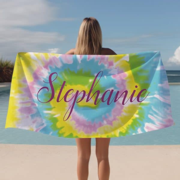 Woman Holding A Tie-Dye Beach Towel With The Name Stephanie On It.