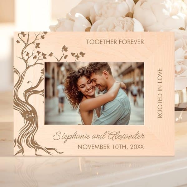 Light Wood Picture Frame With An Engraved Tree Design, Showing A Photo Of A Couple Embracing, Names, And Wedding Date.