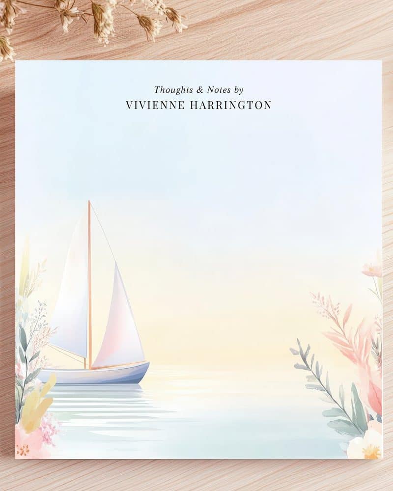 Sailboat on calm water with floral accents, notepad design by Vivienne Harrington.