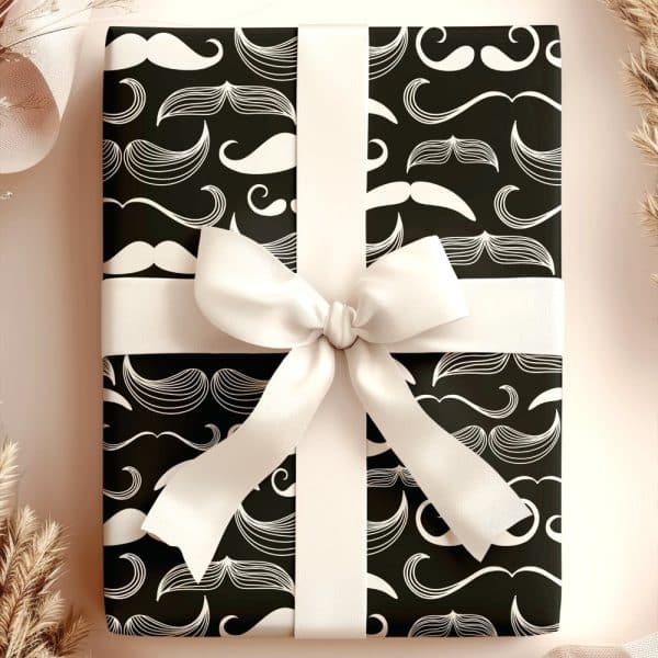 A Gift Wrapped In Black Paper With A White Mustache Pattern And Tied With A Cream-Colored Ribbon.