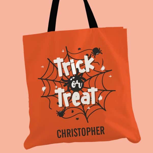Orange Halloween Trick Or Treat Tote Bag With Black Spiderweb Design And The Name Christopher.