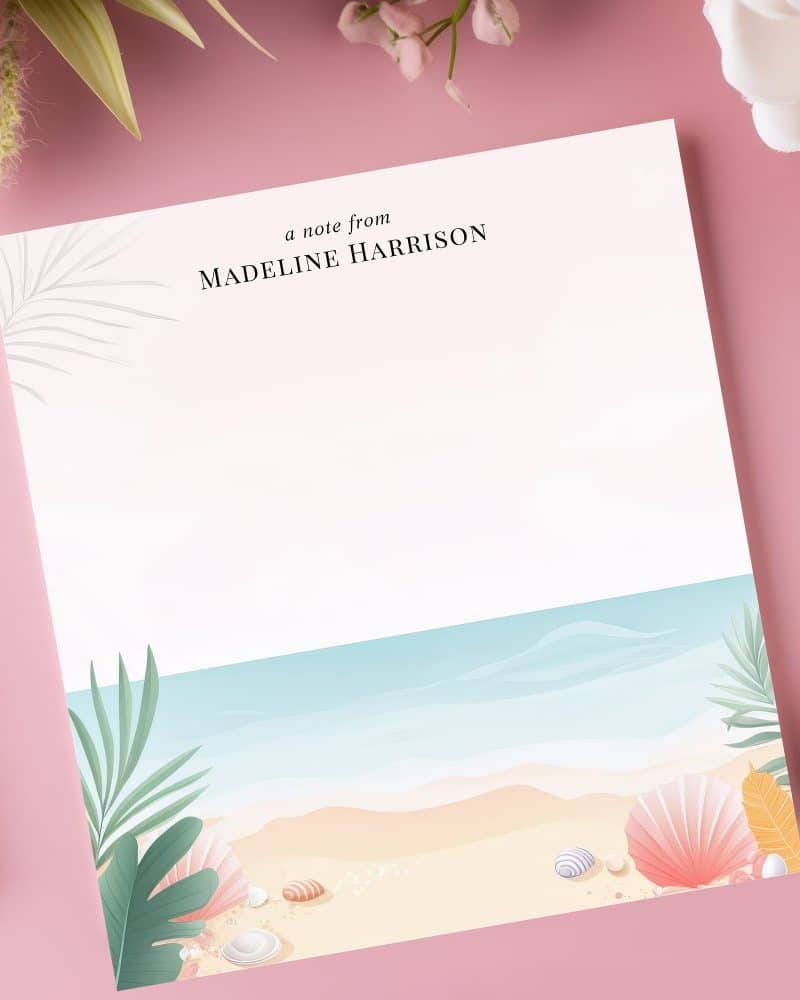 Personalized stationery featuring a beach scene with seashells and palm leaves at the bottom. The top displays Madeline Harrison's name.