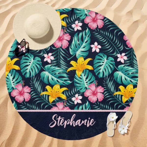 Round Beach Towel With A Navy Tropical Floral Pattern And The Name Stephanie.