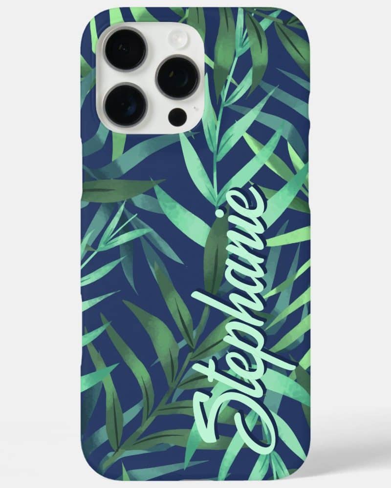 Phone case with a navy blue background and a tropical leaf pattern. The name Stephanie is written on the case in light green.