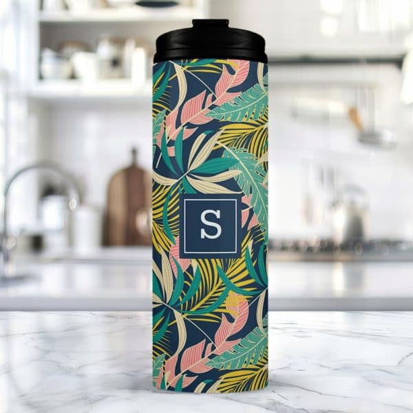 A Tropical Leaf Patterned Travel Tumbler With A Monogrammed Initial S.