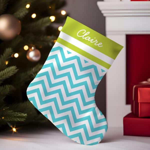 A Teal And White Chevron Patterned Christmas Stocking With The Name Claire On A Lime Green Band.