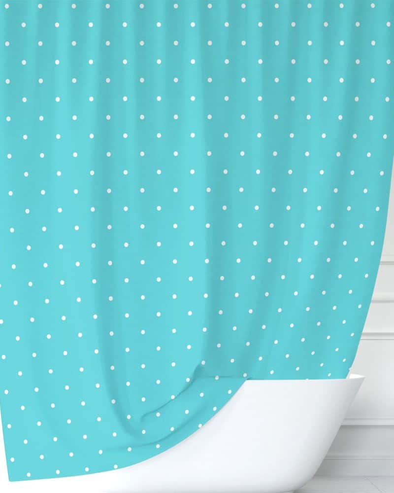 Teal shower curtain with white polka dots.