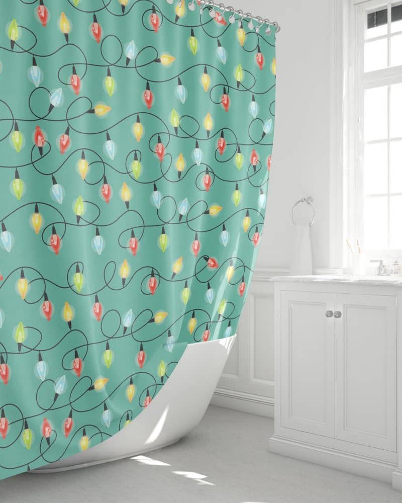 Teal shower curtain with a pattern of colorful Christmas lights.