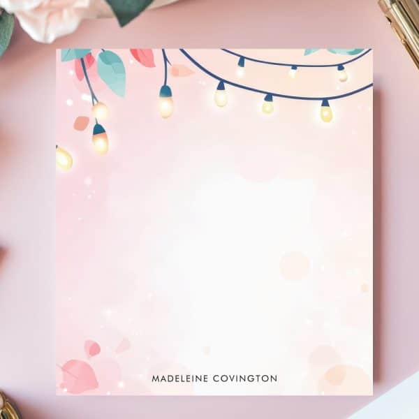 Pink Stationery Featuring String Lights And Leaves In The Upper Left Corner.