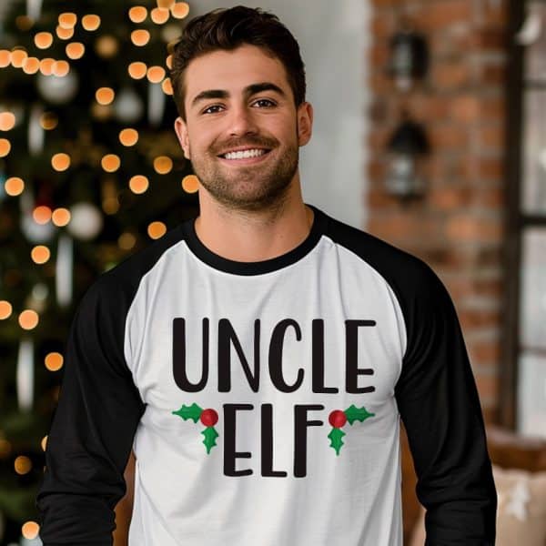 Man Wearing A White And Black Baseball-Style Long-Sleeved Shirt That Says Uncle Elf.