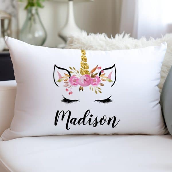 White Rectangular Pillow With A Floral Unicorn Design And The Name Madison.