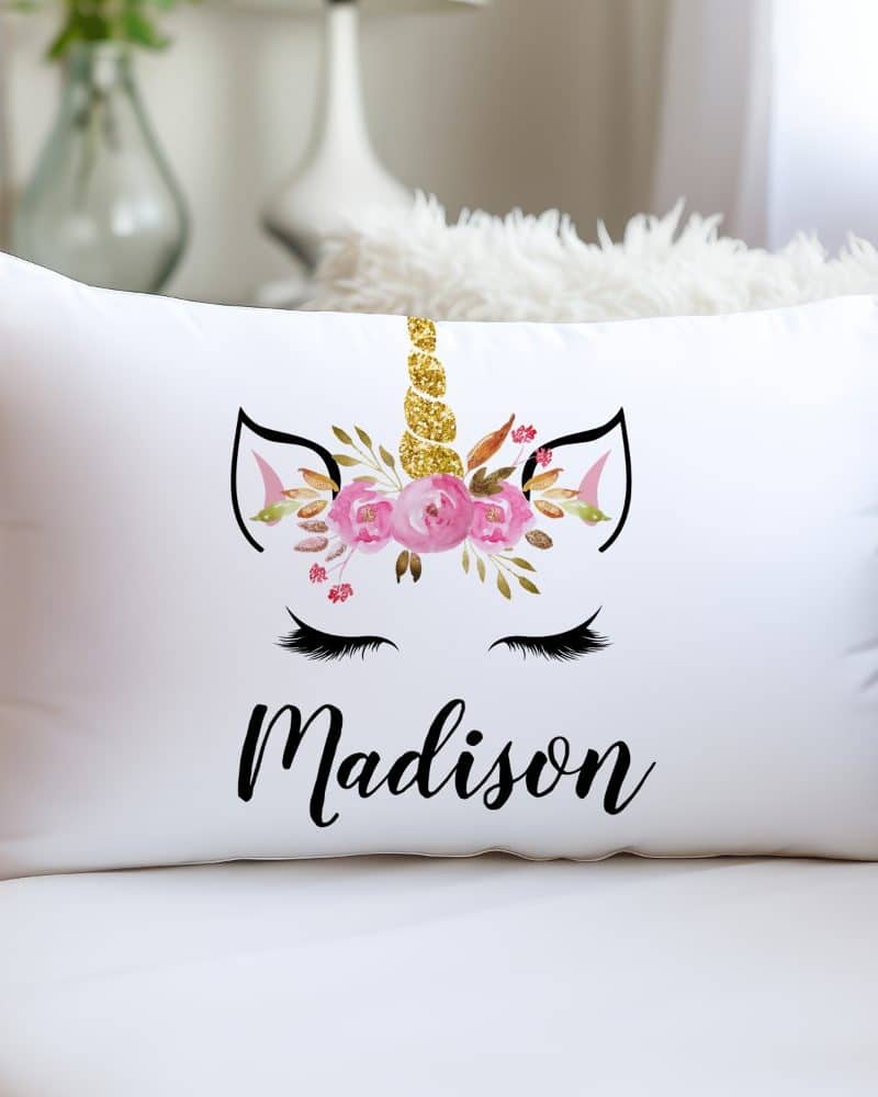 White rectangular pillow with a floral unicorn design and the name Madison.