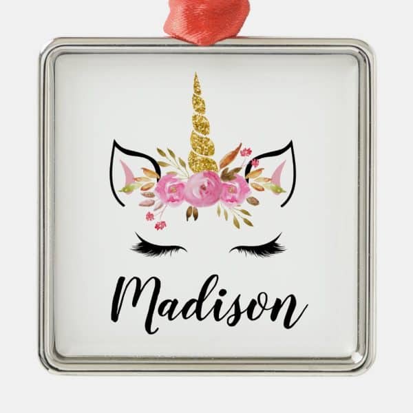 Silver Square Ornament Featuring A Unicorn Face With A Gold Glitter Horn And Pink Flowers, The Name Madison Below.