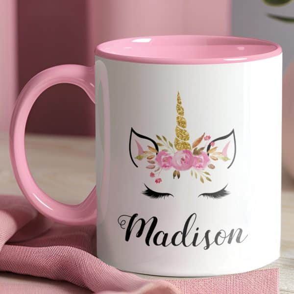 Pink Mug With A Unicorn Face And The Name Madison.