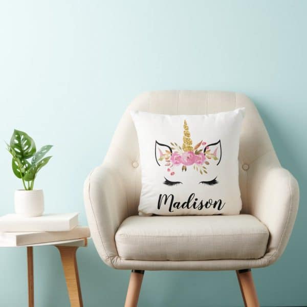 A Cream-Colored Pillow With A Floral Unicorn Design And The Name Madison.
