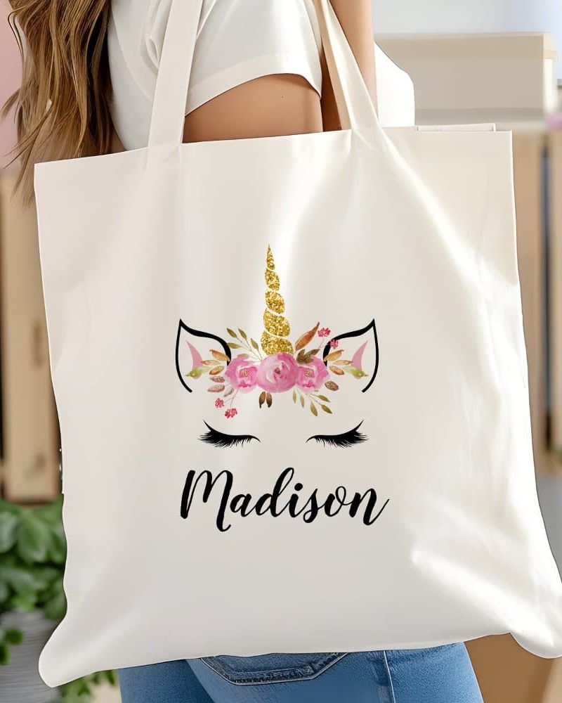 White tote bag with a floral unicorn design and the name Madison.