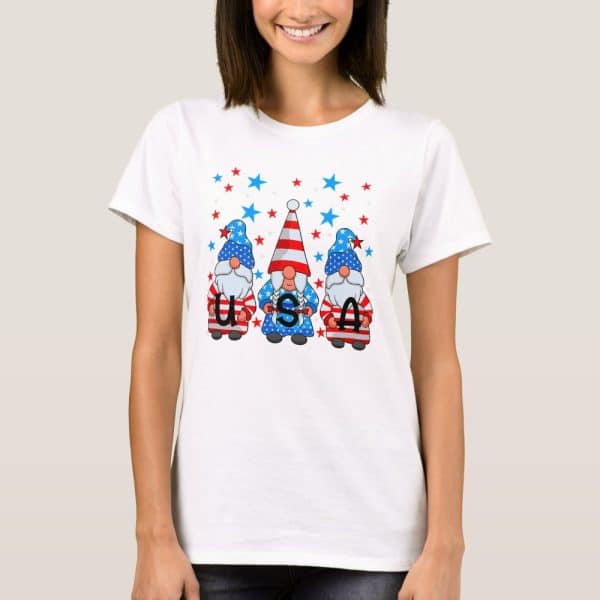 Woman Wearing A White T-Shirt Featuring Three Gnomes In Patriotic Attire Spelling Usa.