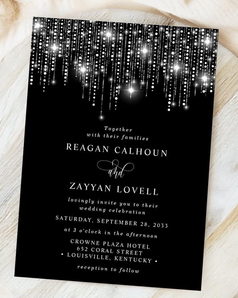 Black wedding invitation with silver glitter detailing.