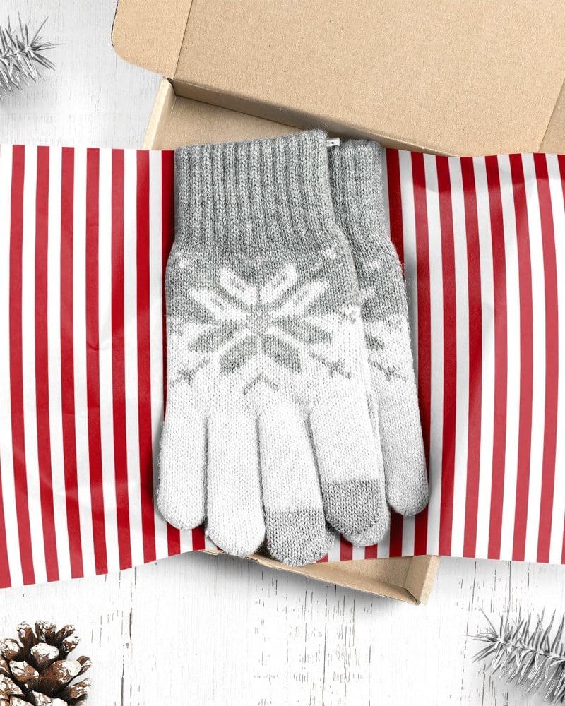 Grey and white snowflake patterned gloves in a gift box.