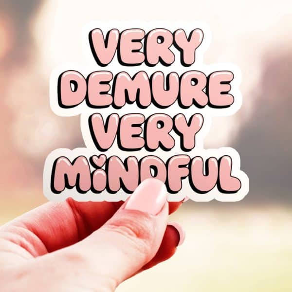 Hand Holding A Pink Sticker That Says Very Demure Very Mindful.