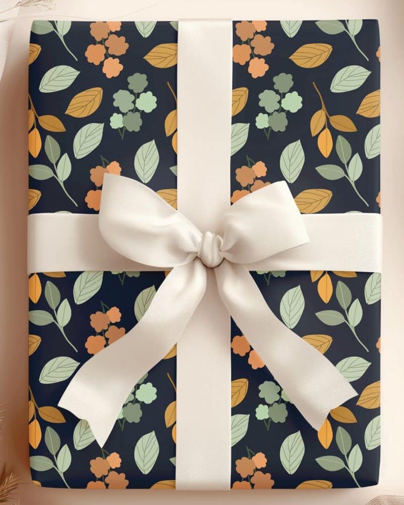 Gift box with a dark background floral pattern and cream-colored ribbon.